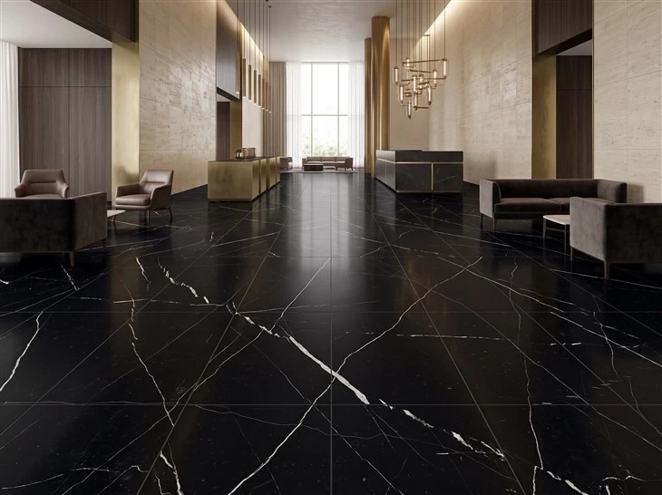 Large-format Nero Marquina marble floor tiles with visible dark joints in a luxury hotel lobby